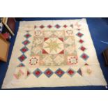 Victorian pieced patchwork framed quilt in plain and polychrome floral cottons with central star