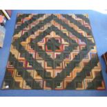 Late 19th/early 20th century "Log Cabin" pattern patchwork bedspread in cotton, silk and wool, the