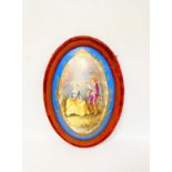 19th century French porcelain Sevres-style oval wall-plaque within a velvet and wood frame, the