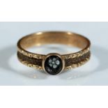 Victorian gold tone mourning ring set with carved black cameo in the form of a flower, the