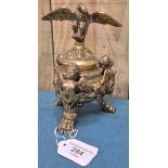 Antique heavy brass ink well pot; Lid designed with an eagle finial. Body detailed with three cherub