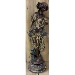 Large bronze sculpture depicting a young maiden holding a floral garland in the manner of Auguste