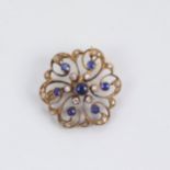 An early 20th century sapphire and diamond brooch/pendant, with central sapphire within surround