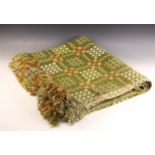 A large Welsh wool blanket, with an all-over traditional geometric design against a green ground