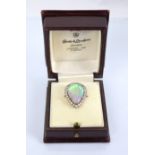 A large opal and diamond pear shaped ring, mid 20th century, the central oval cabochon opal (