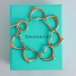A contemporary Tiffany bracelet, by Elsa Peretti, the six openwork heart shaped links with toggle