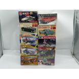 A boxed group of mixed 1/24–1/25 scale US car and character kits,