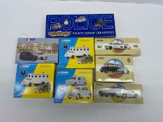 A boxed group of Corgi police-themed die-cast model sets