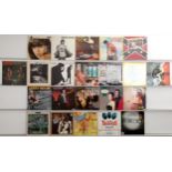 An eclectic collection of vinyl records spanning genres such as pop, rock, easy listening, and cl...