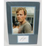 Ewan McGregor autographed display featuring a signature in black ink on a white card, professiona...