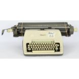 An Olympia Werke AG Wilhelmshaven typewriter, finished in a cream and grey casing …
