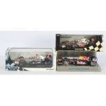 Minichamps and Hot Wheels, a boxed and unboxed trio of 1:18 scale Formula 1 racing…