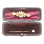 Victorian 9ct gold brooch set with garnets and seed pearls, and a 9ct gold stick pin set with a