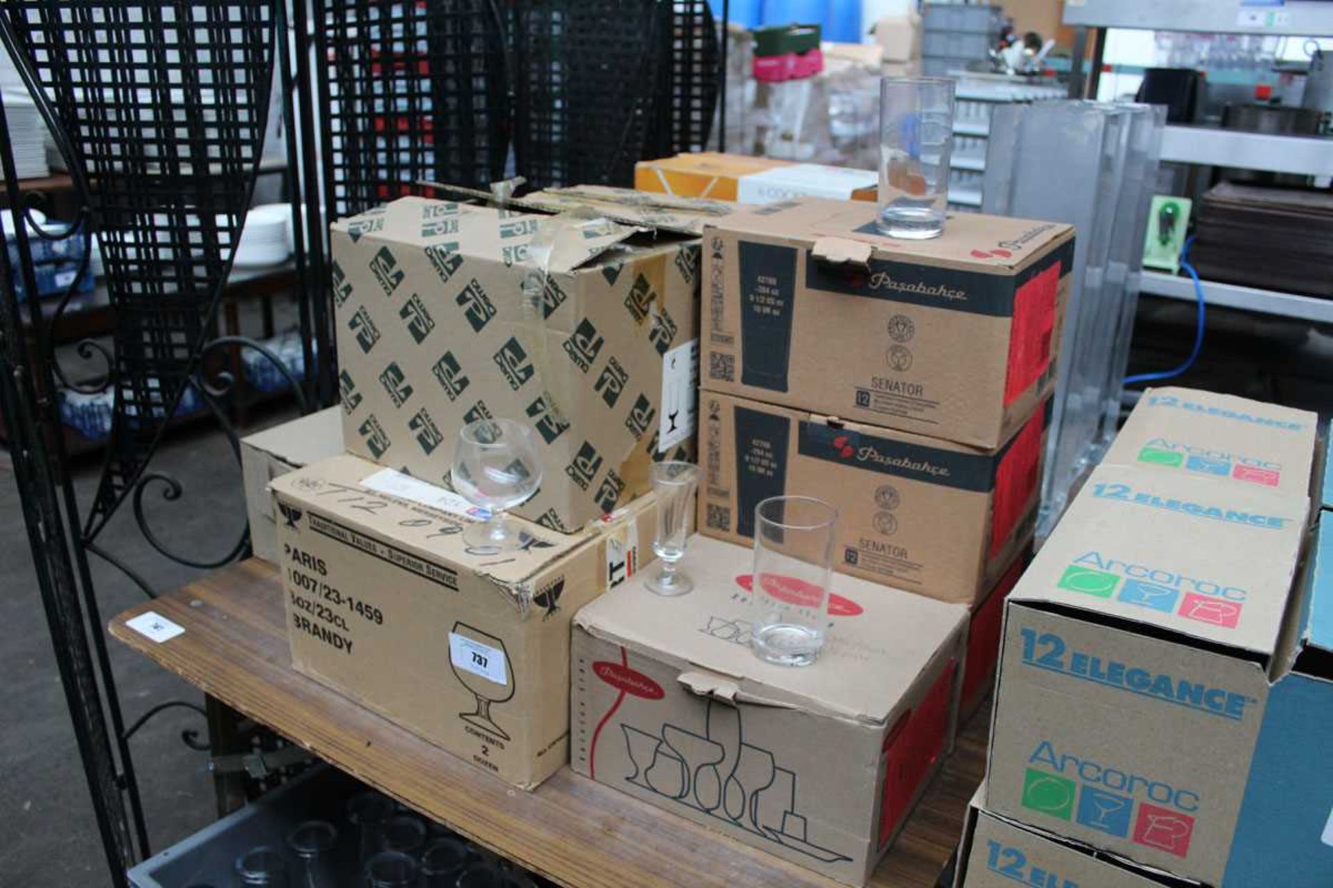 +VAT Table top of glassware to include three boxes of Pasabahche Senator, two boxes of Beamer