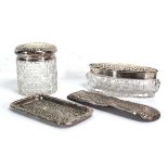 Three early 20th century silver dressing table items comprising two bottles and a small tray, w.