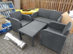 Black rattan 4 piece garden seating set comprising 2 seater sofa, 2 armchairs and matching coffee