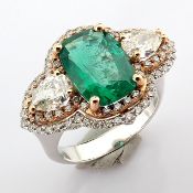 An exquisite ring detailed with vibrand emerald, different cut