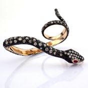 A snake ring detailed with brilliant diamonds and gold on