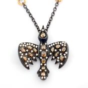 An exquisite bird necklace detailed with brilliant diamonds and gold on