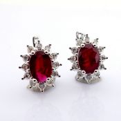 18K White gold cluster earrings detailed with ruby and brilliant