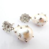 An exquisite earrings detailed with baroque pearl, brilliant diamonds and