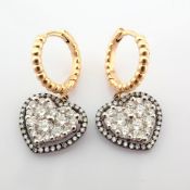 18K yellow and white gold heart earrings detailed with brilliant