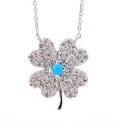 An exquisite 18k white gold clover necklace detailed with turquoise and brilliant