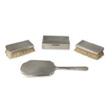 A PAIR OF ART DECO SILVER ENGINE TURNED MILITARY HAIR BRUSHES, LONDON 1945
