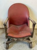 Wooden armchair with red leather-studded seat cover
