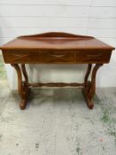 A Lyre console desk, with three drawers, galleried top and turned cross streatcher. Height 90cm
