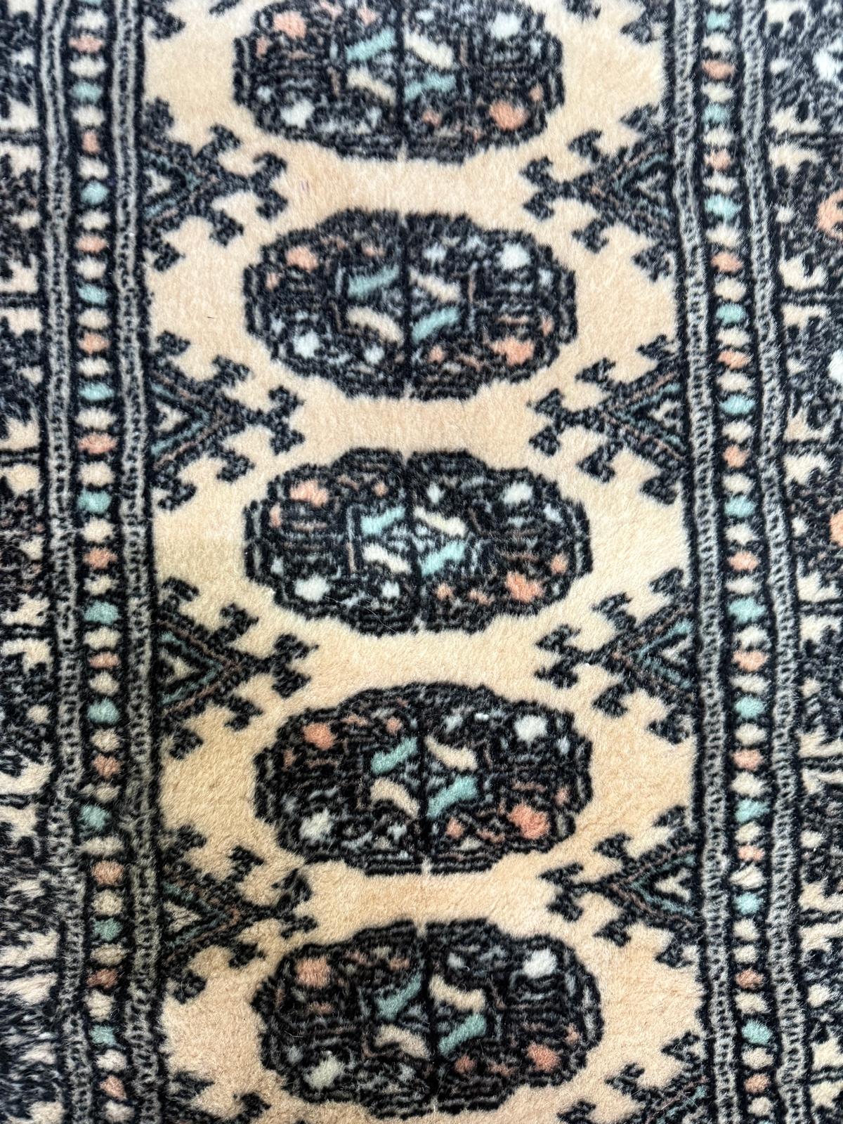 A wool rug. Beige grounds with geometric border.65x100cm - Image 2 of 4