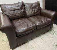 A brown two seater leather sofa