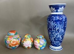 Three graduated ginger jars together with a blue and white Chinese vase