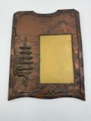 An antique Japanese copper picture frame with repousse design of a pagoda and Mount Fuji 29cm x