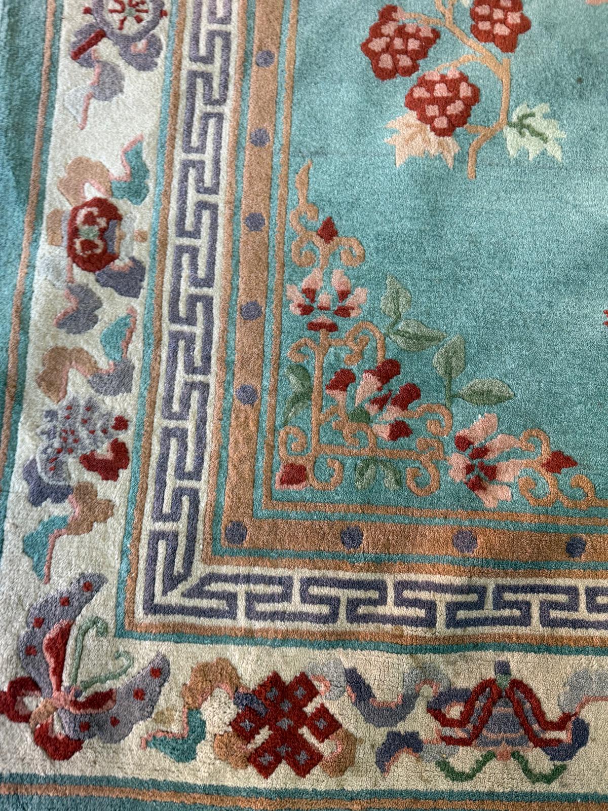 A wool rug, blue grounds with a floral border and central pattern (220cm x 124cm) - Image 2 of 4
