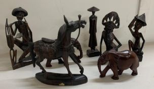 A selection of wooden animals and tribal figures in various styles