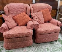 Two wingback armchairs upholstered in a red and cream diamond upholstery