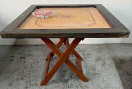 A Carrom board with a stand and counters