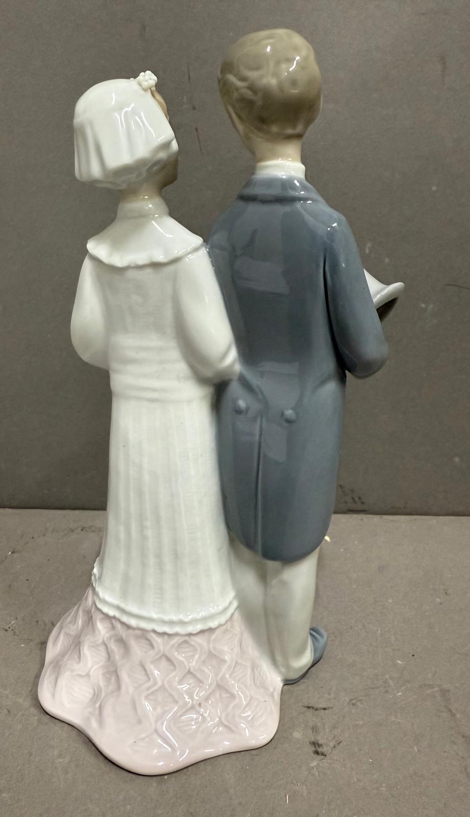 A Lladro figure of a bride and groom on their wedding day. - Image 2 of 4