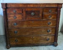 A Regency mahogany chest of drawers comprising of one central deep drawer flanked by four short