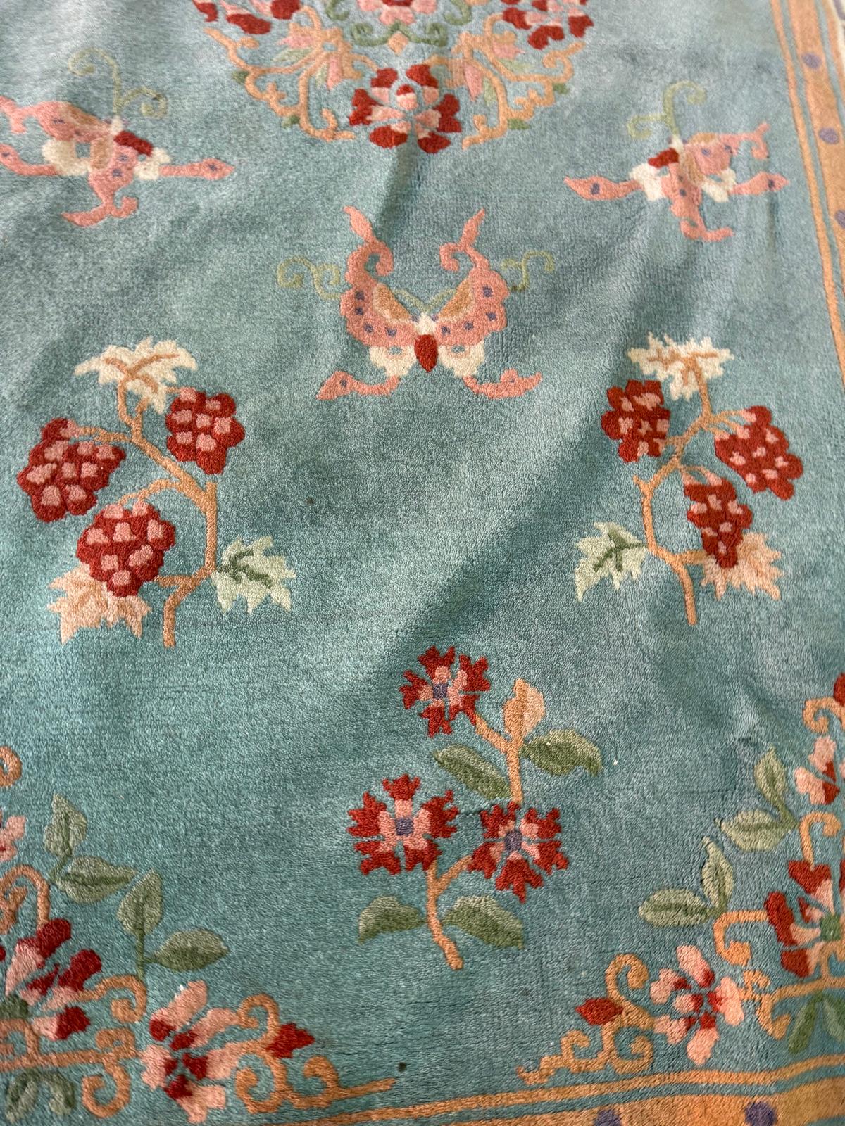 A wool rug, blue grounds with a floral border and central pattern (220cm x 124cm) - Image 4 of 4