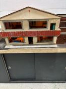 A doll's house on a cabinet with a selection of doll's house furniture with working lights AF