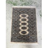 A wool prayer mat. Beige grounds with geometric border . 65x98cm