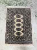 A wool prayer mat. Beige grounds with geometric border . 65x98cm