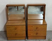 A pair of Mid Century two drawer bedside tables with mirrored glass shelving to top by New