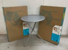 A silver metal circular garden table and two boxed Sorrento garden armchairs