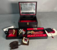 A selection of costume jewellery in a black jewellery box, a variety of styles and finishes to