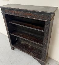 A carved oak open bookcase H 107cm x D 27cm x W 91cm