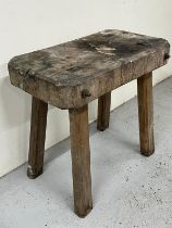 A rustic oak butchers block on four straight legs H 73cm x W 76 cm x D 48cm.