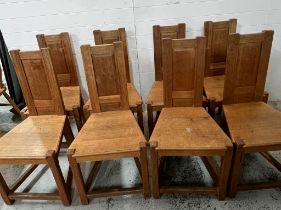 Eight oak Arts and Crafts chapel style chairs. Simple panelled back in solid oak seat base on square